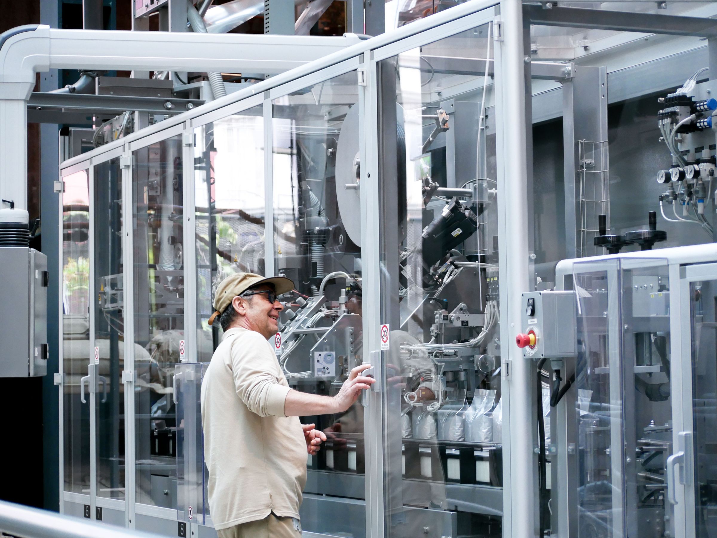 Technician at a guarded automated machine