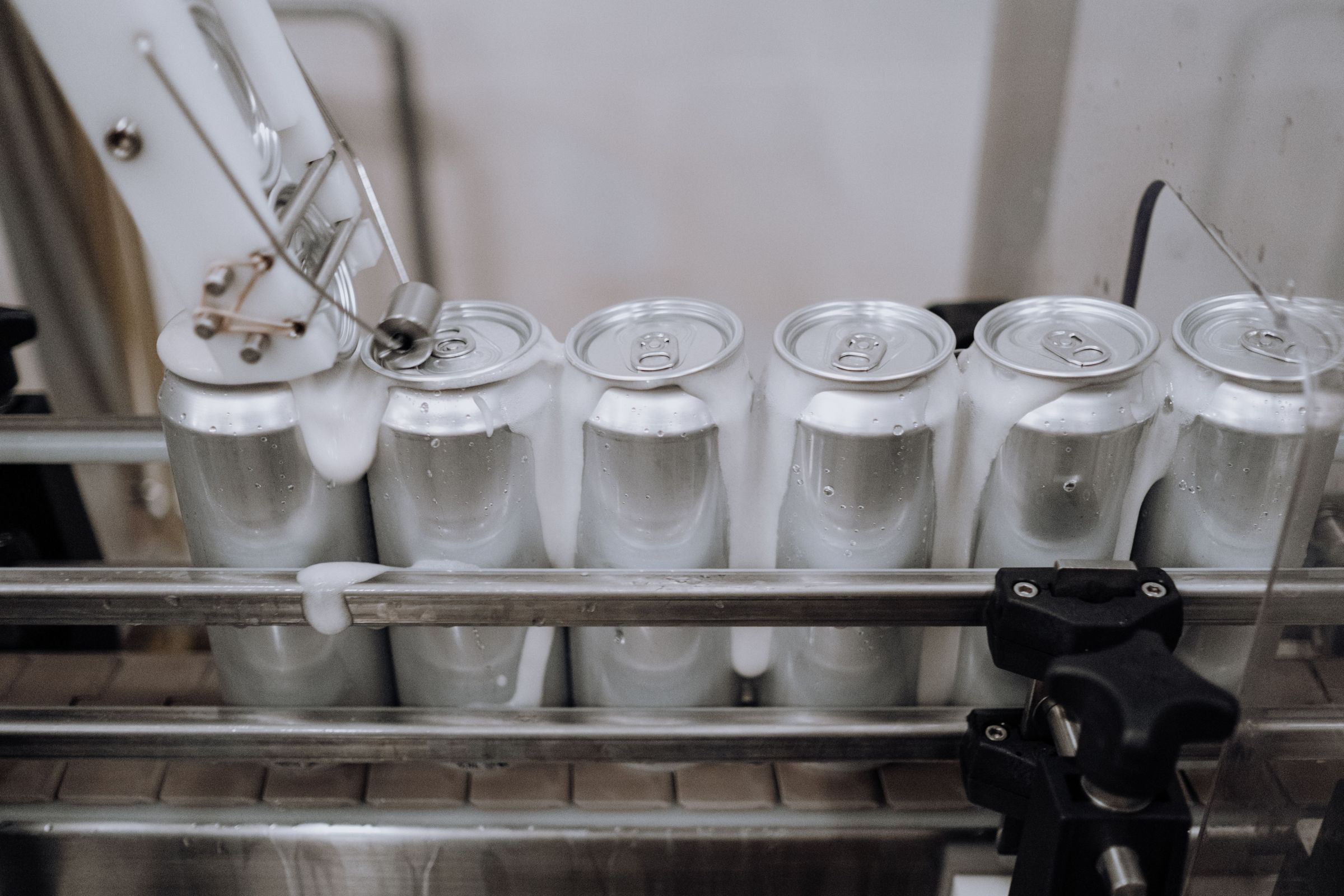 Cans moving along a production conveyor